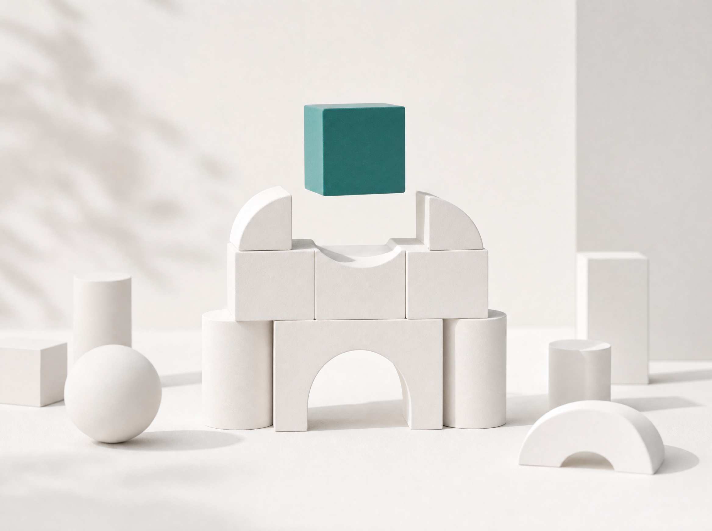 White building blocks with one teal block placed mid-air